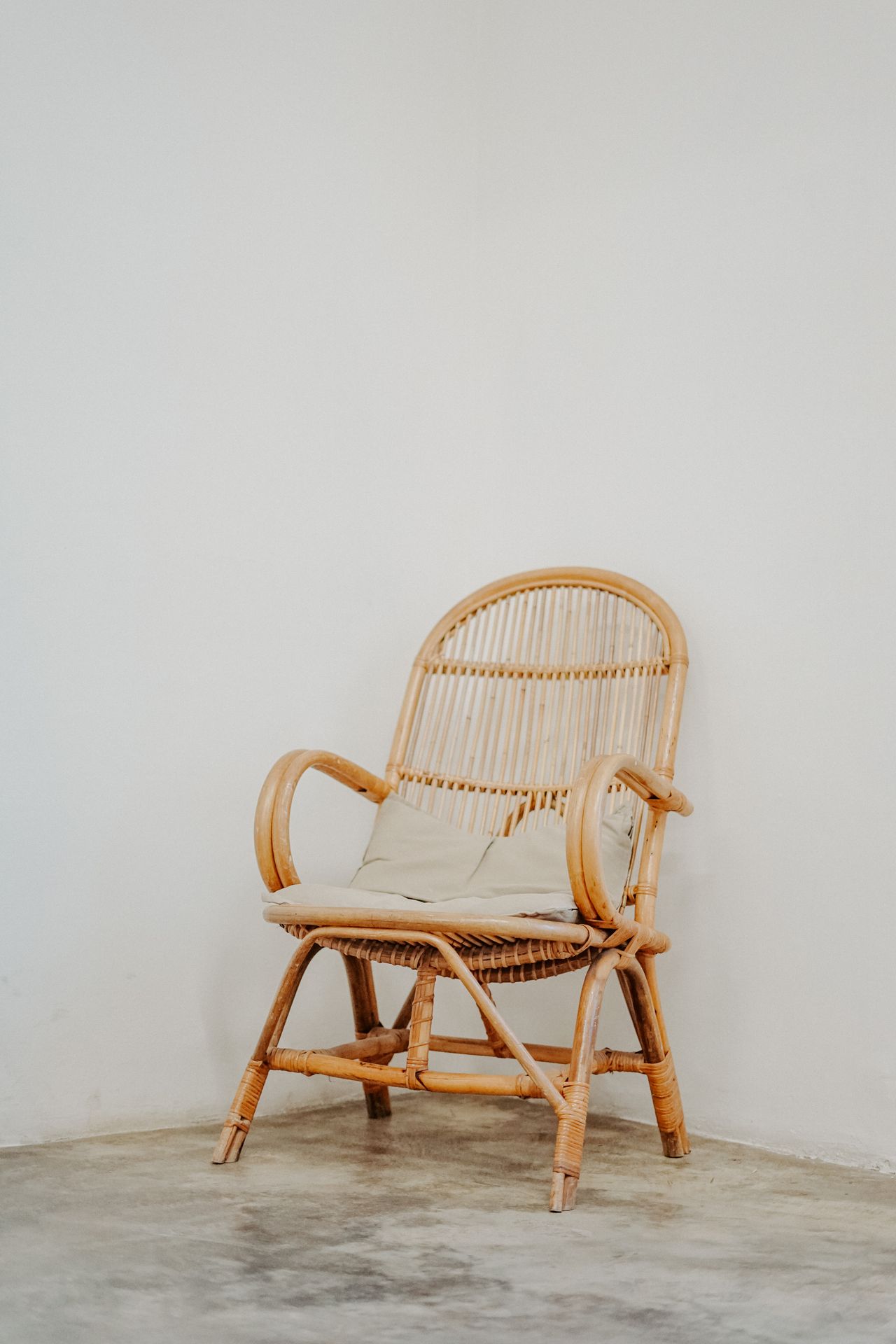 rattan-furniture-boho-bedroom Rattan chair in a warm bedroom corner