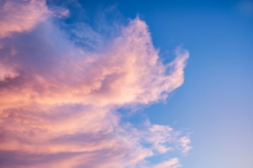 Free A stunning view of pink clouds with a serene blue sky background, perfect for tranquil and inspiring purposes. Stock Photo