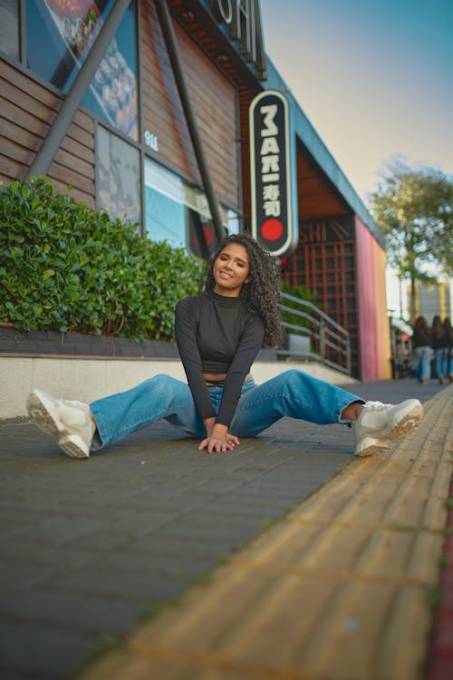 A Woman Sitting on the Sidewalk