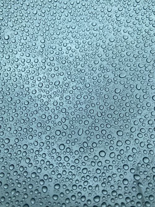 Free Detailed view of water droplets on a smooth glass surface creating a pattern. Stock Photo