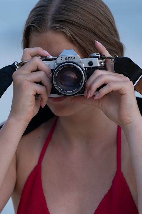 A Woman Taking Photo with an Analog Canon Camera