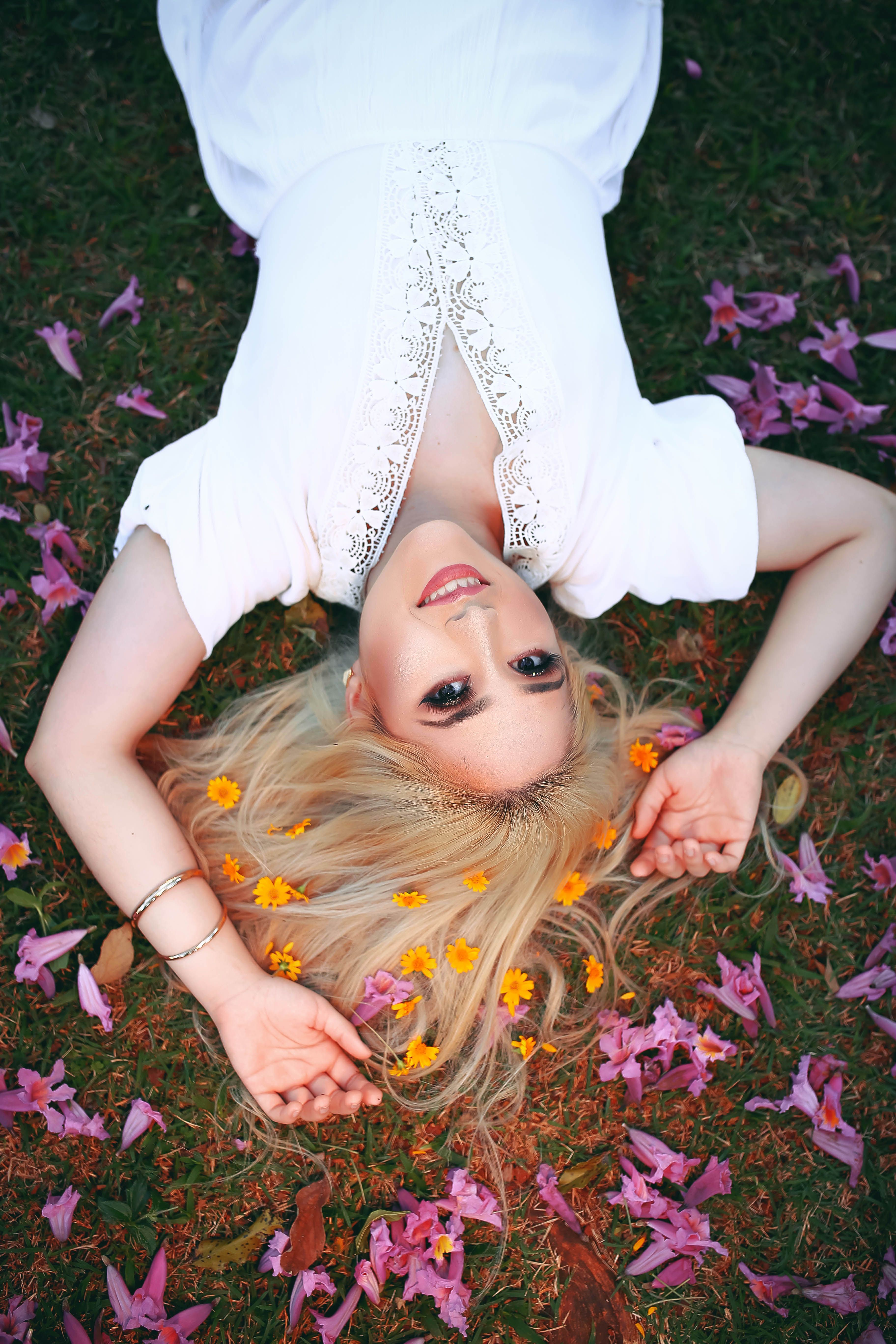 A Woman in White Dress Lying on Grass · Free Stock Photo