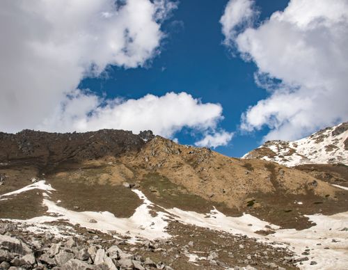 Free A breathtaking view of snow-capped mountains under a clear blue sky, showcasing nature's beauty. Stock Photo