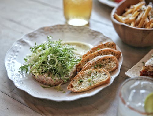 A Plate of Toasted Slices of Breads with Green Leafy Vegetables