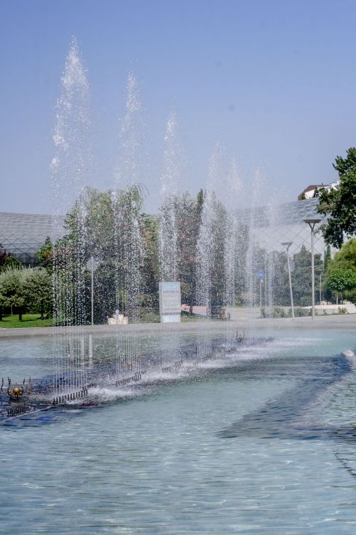 Free A tranquil shot of fountains in Rike Park, Tbilisi, with clear blue skies and lush greenery. Stock Photo