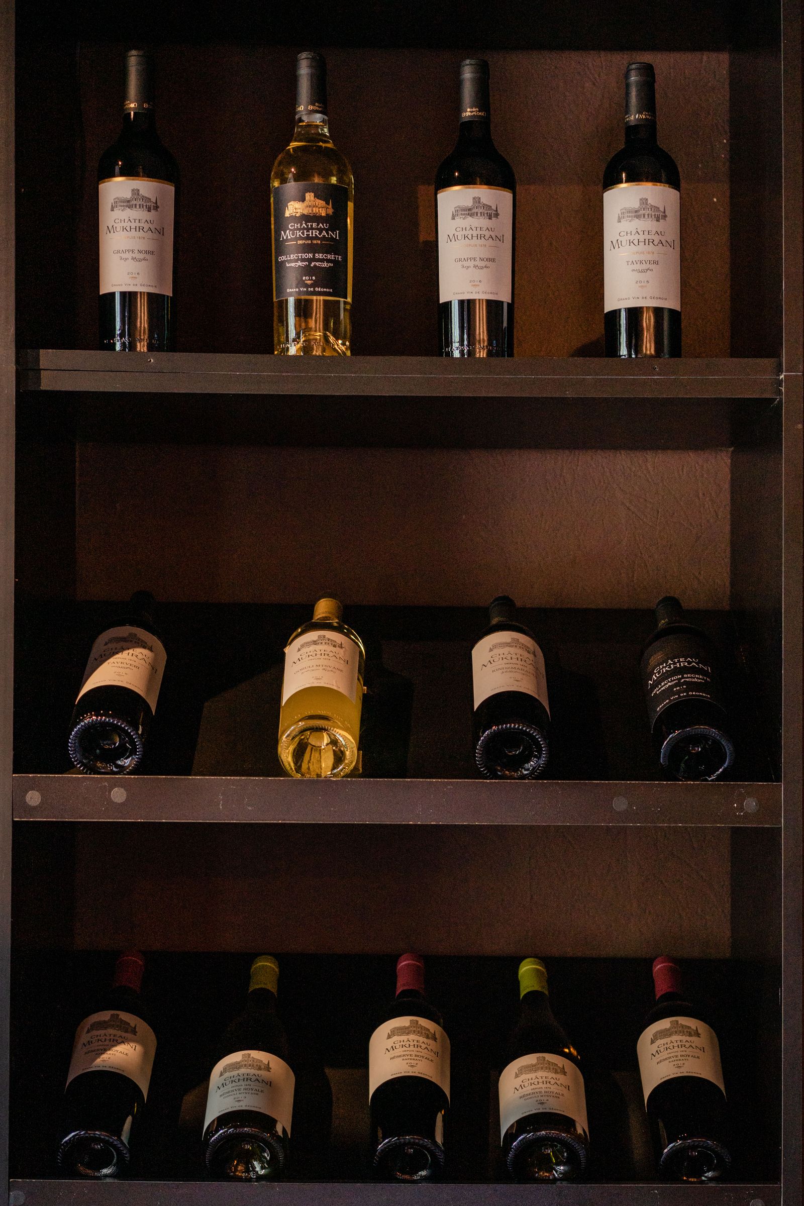 A modern Italian wine bar interior with wine bottles on display