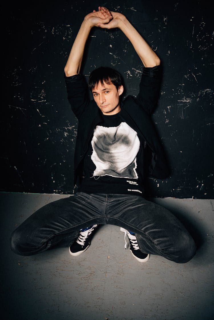 Man In Casual Clothes Posing Near Wall Indoors