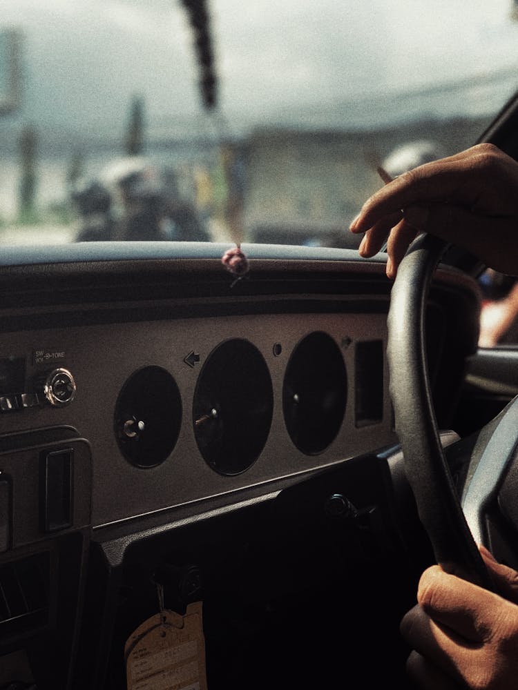 Hands Placed On Steering Wheel Of Vintage Car