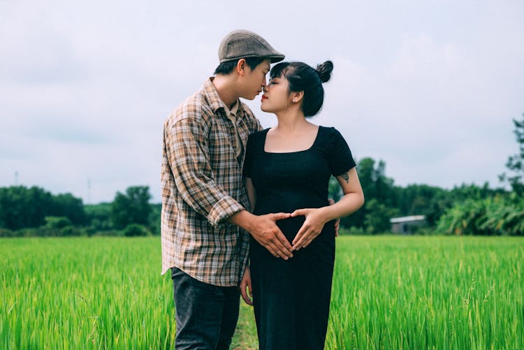 Expecting Parents In A Field