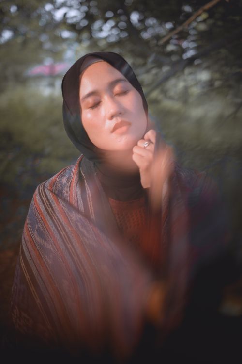 Free Close-up portrait of a serene woman wearing a hijab outdoors with eyes closed, exuding tranquility. Stock Photo