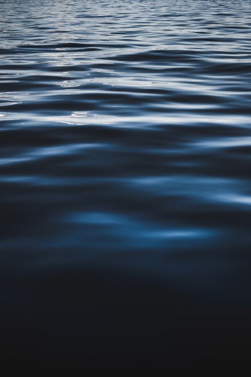 Free Close-up view of serene ocean waves in low light, emphasizing tranquility. Stock Photo