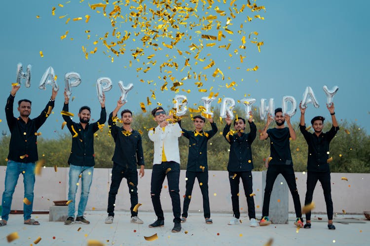 Group Of Friends Holding Birthday Balloons