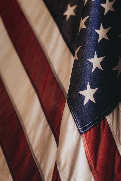 Free Patriotic close-up of the United States flag showcasing the stars and stripes pattern. Stock Photo