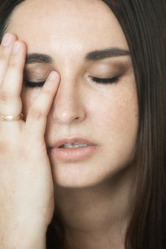 Intimate close-up of a woman with eyes closed, conveying emotion with soft tones.