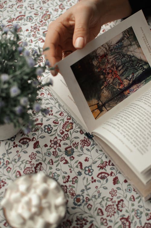 White Book Page on White and Red Floral Surface