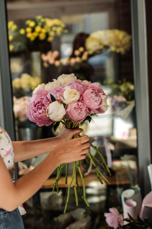 Person Holding Pink and White Flower Bouquet