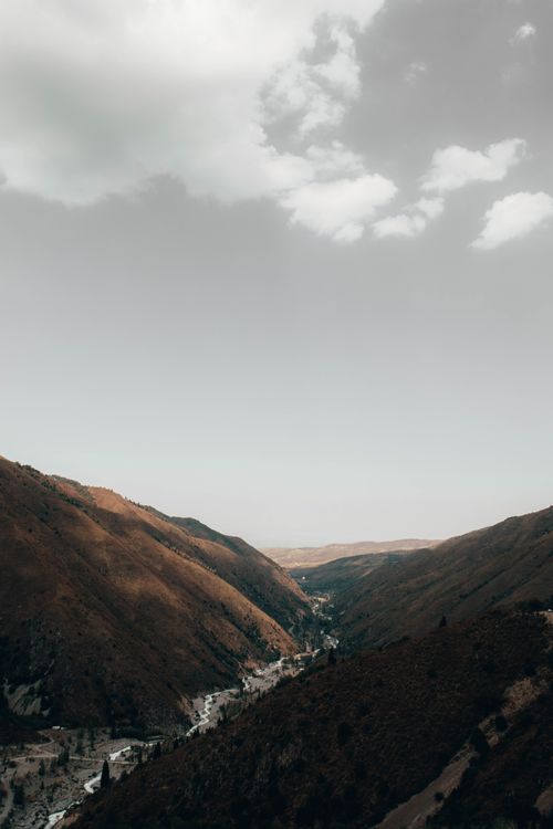 Free A breathtaking view of a mountain valley under a gray sky in Kazakhstan, captured outdoors. Stock Photo