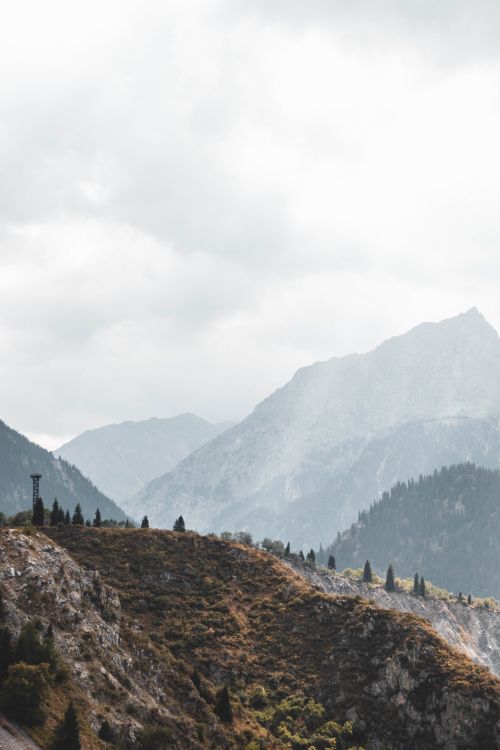 Free Stunning aerial view of mountains in Almaty, Kazakhstan under a cloudy sky. Stock Photo