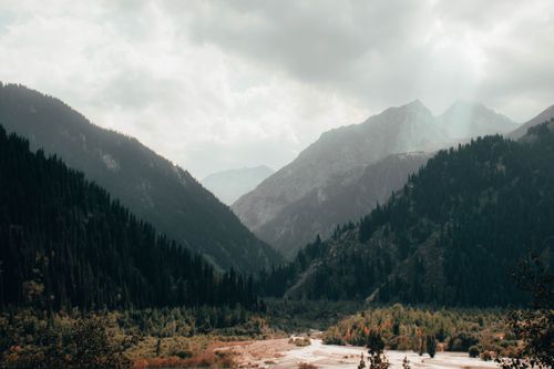 Free Stunning view of mountains and valley in Almaty, Kazakhstan with a foggy ambiance. Stock Photo