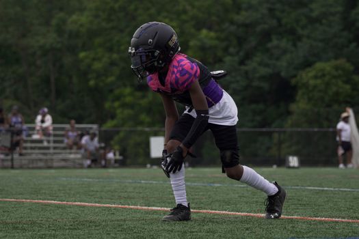 Youth football player in action on the field in Columbia, MD.
