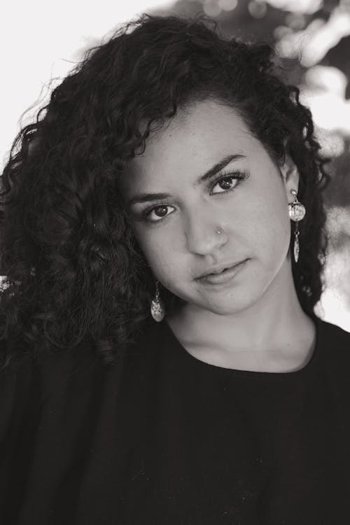 Free Woman Wearing a Black Shirt and Earrings  Stock Photo