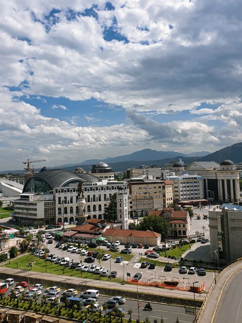 Free Aerial view of Skopje showcasing diverse architecture and vibrant urban life under a cloudy sky. Stock Photo