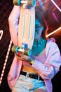 Woman in Blue Jacket Holding Blue and White Water Pipe