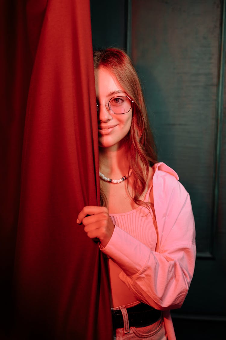 A Beautiful Woman Hiding Behind A Curtain