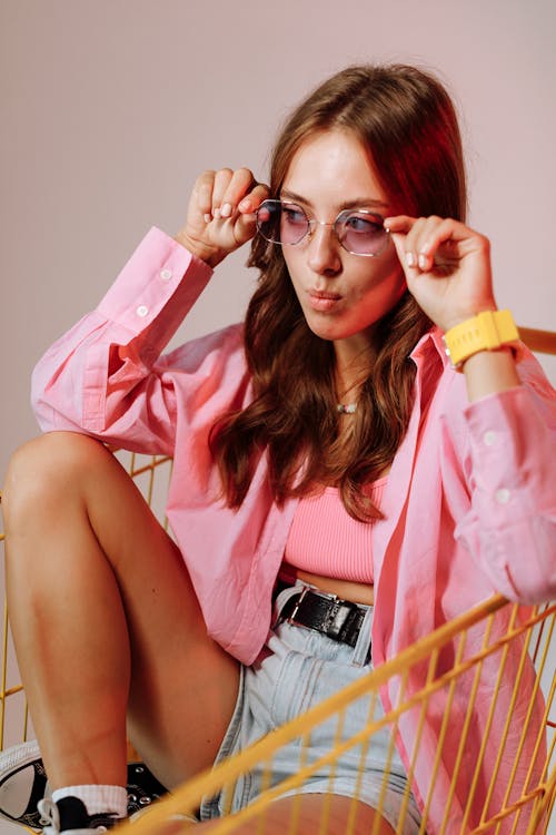 Woman in Pink Sleeveless Shirt Wearing Eyeglasses