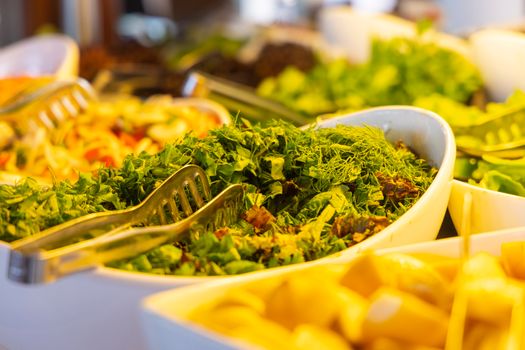 Close-up of a vibrant salad bar featuring fresh greens and vegetables, perfect for healthy eating.