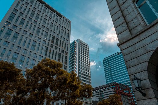 A stunning view of modern skyscrapers in a city against a blue sky.