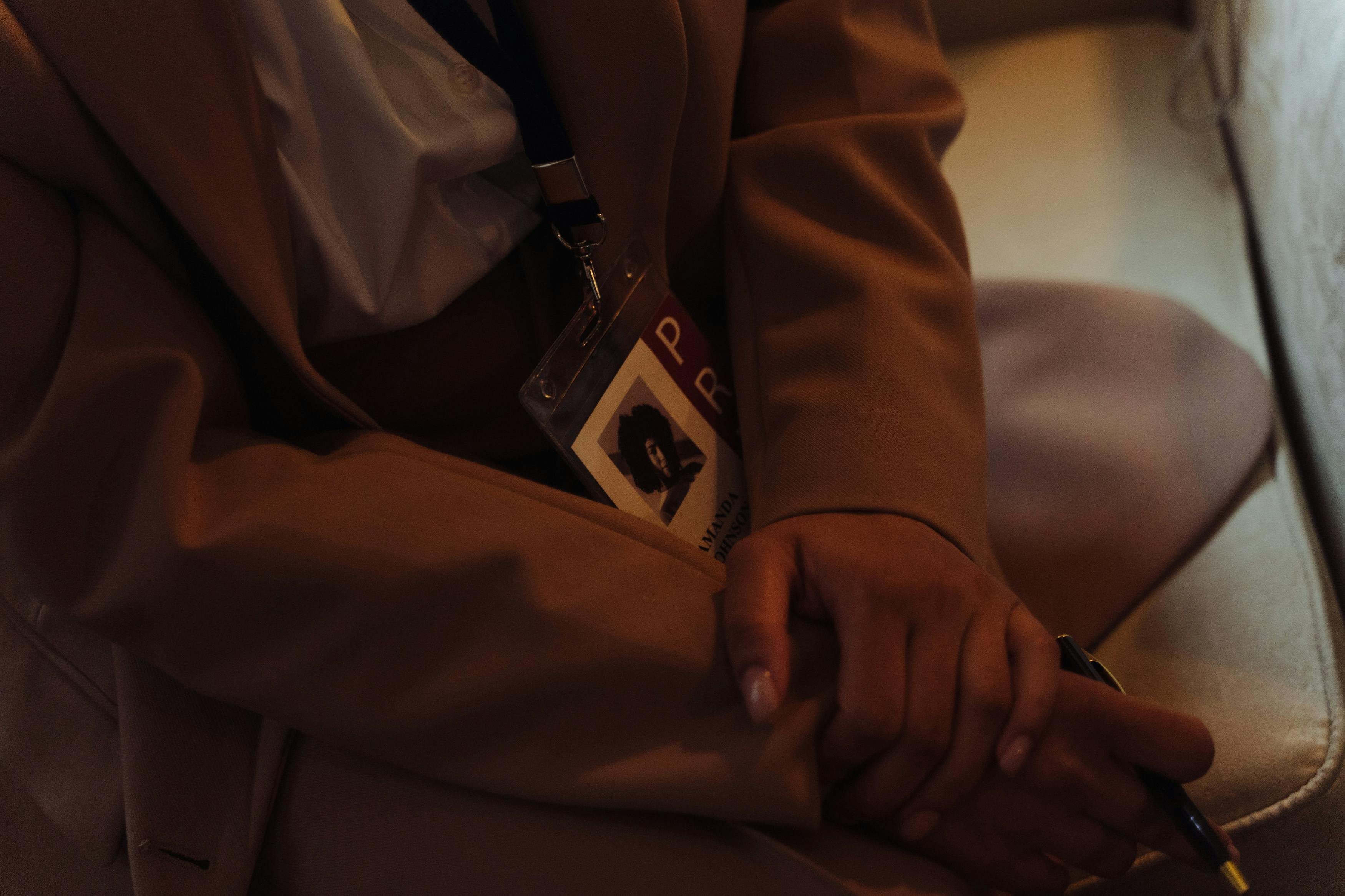 a person in brown coat weaering identification badge