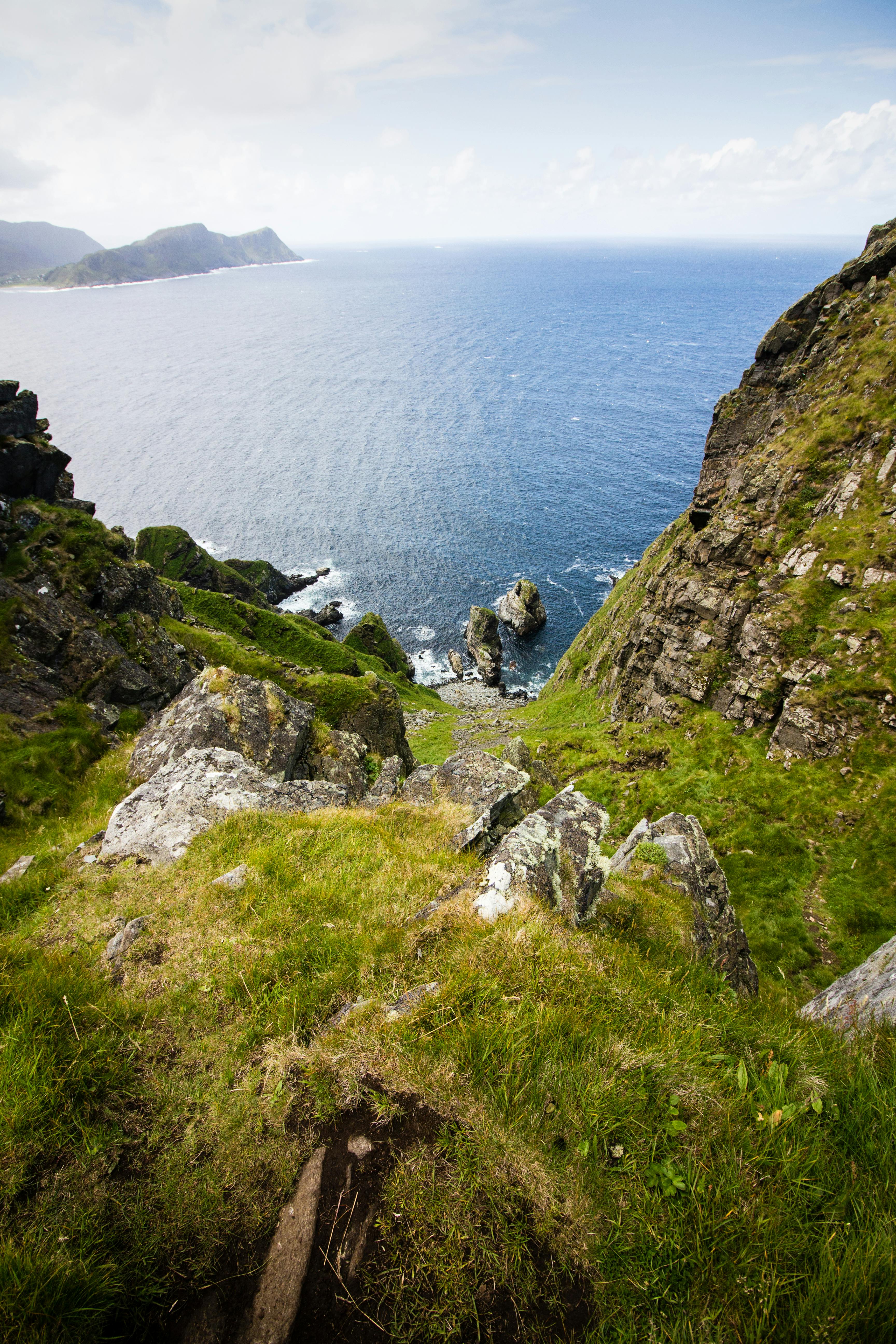 Stunning rocky cliffs and ocean views in Runde, Norway, perfect for nature lovers.