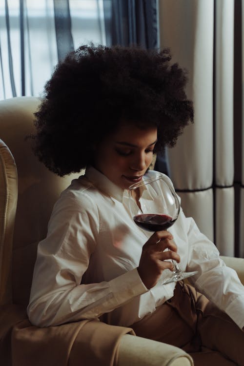Free Woman in White Long Sleeve Shirt Holding Wine Glass Stock Photo