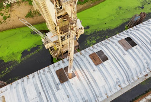 High Angle Photography of a Heavy Machinery on Water