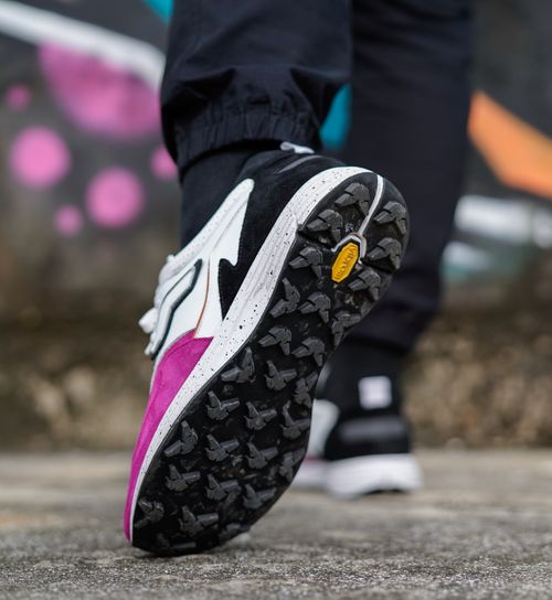 Free Stylish sneakers in a modern urban setting with vibrant graffiti art. Stock Photo