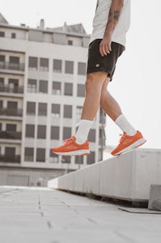 Close-up of a person wearing orange sneakers, showcasing urban style and dynamic fashion.