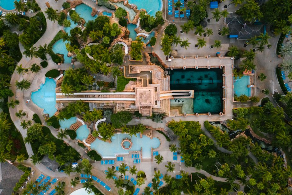 Outstanding After-hours 23 Miles Private Helicopter Tour over Orlando Eye Review 2026 - Stunning aerial view of a luxurious tropical resort featuring multiple pools and lush greenery.