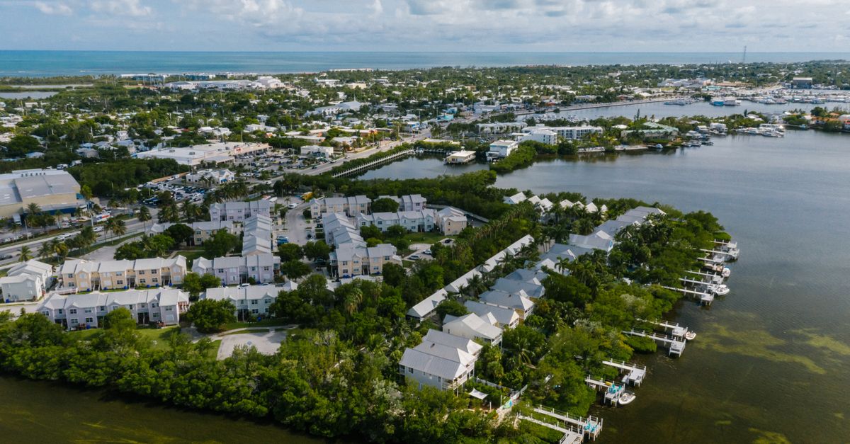 A stunning aerial view of Key West showcasing waterfront buildings, greenery, and cityscape.