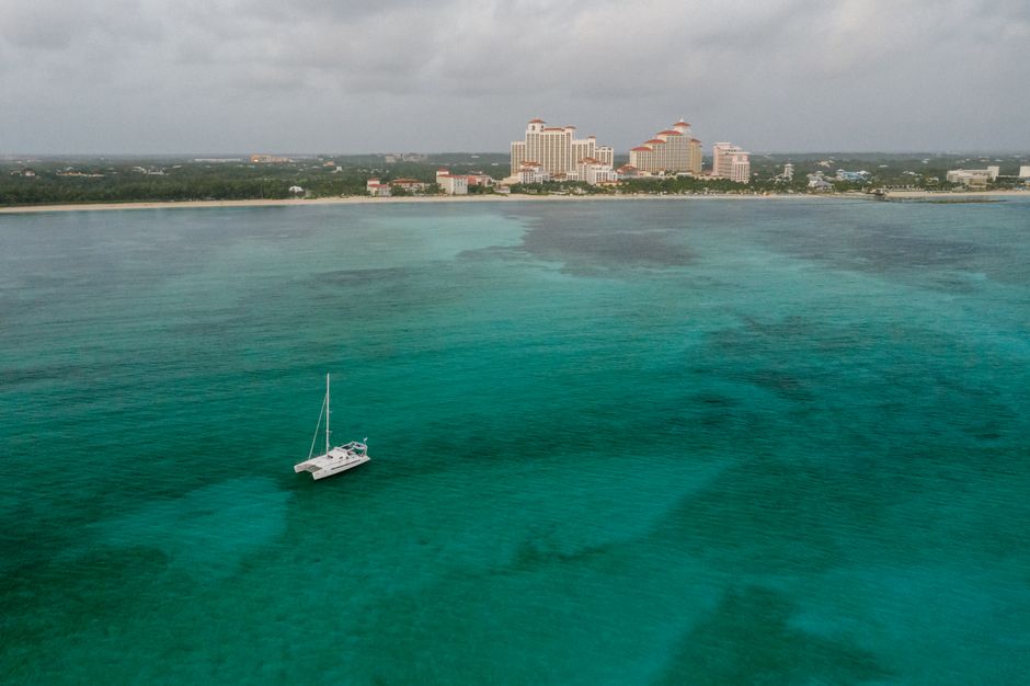 Ultimate Exuma Day Away - Original Swimming Pigs Excursion Review: The Ultimate Bahamas Adventure Review 2026 - Aerial shot of a sailboat in the turquoise waters near a beachfront resort in the Bahamas.