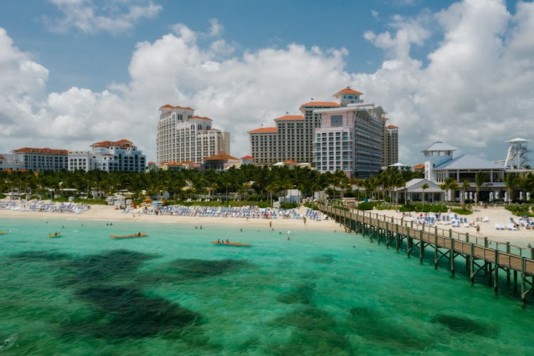 People On Beach Near High Rise Buildings