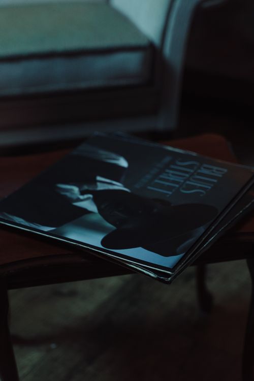 Free Close-up of classic vinyl records on a wooden table in a cozy interior setting. Stock Photo