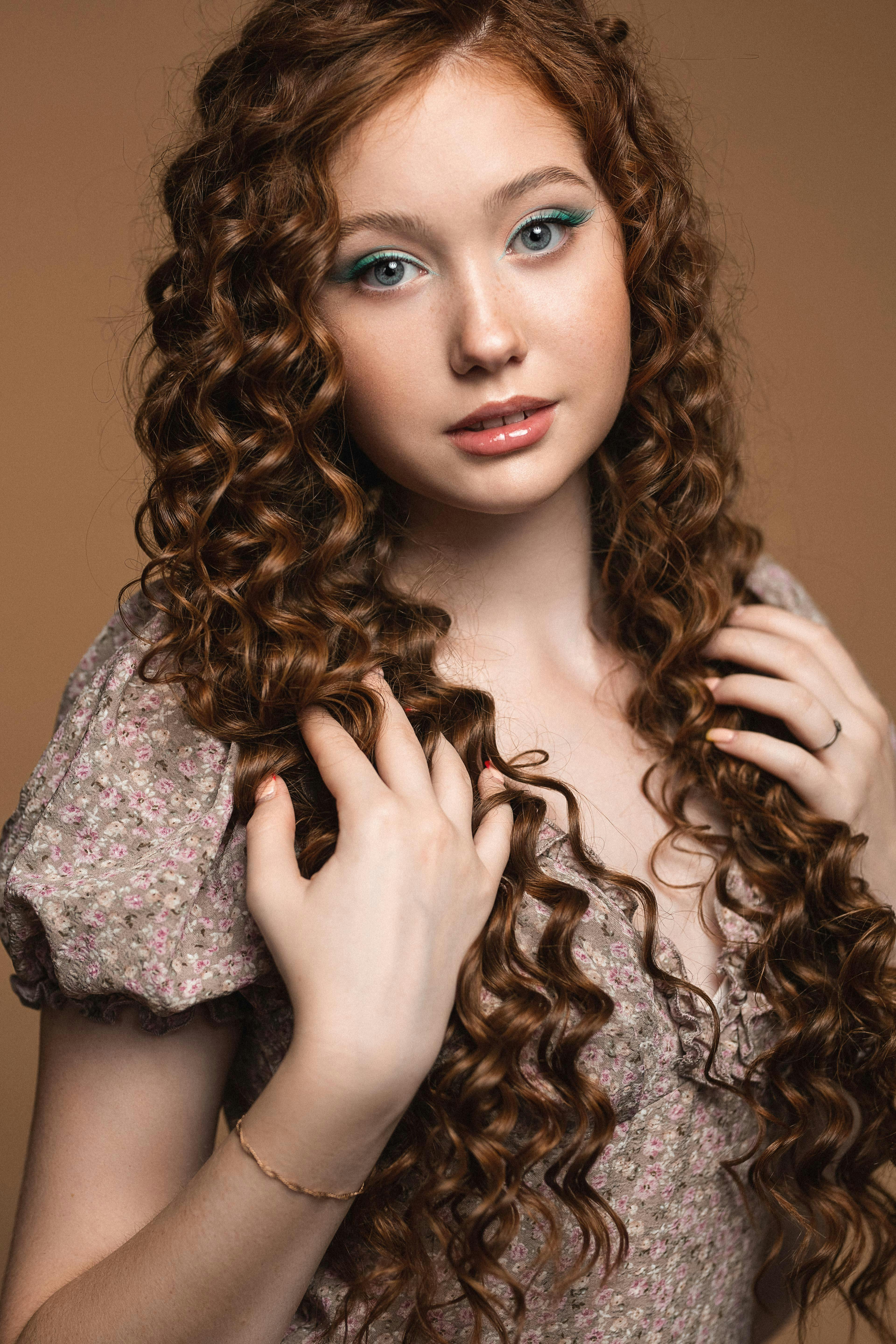 A Pretty Woman with Long Brown Curly Hair · Free Stock Photo