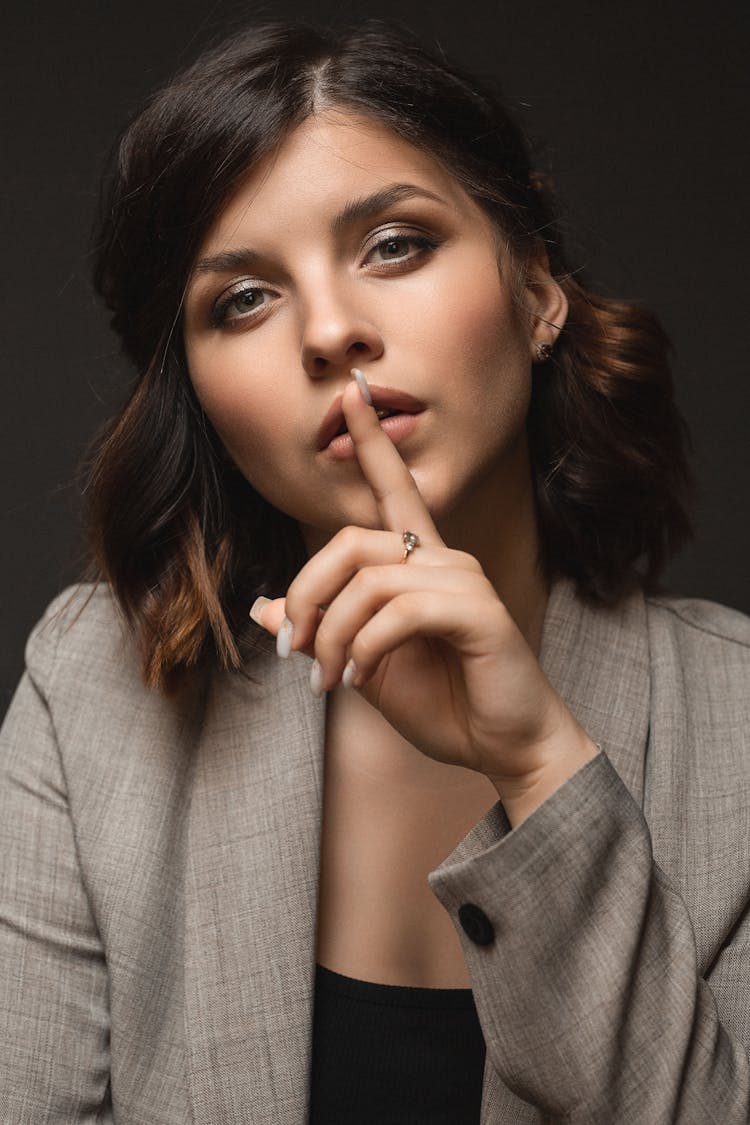 Portrait Of A Woman Doing The Shush Gesture