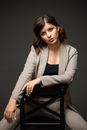 Woman in Gray Cardigan Sitting on Black Chair