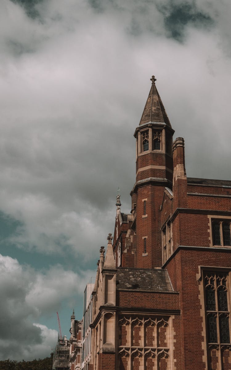 Old Gothic City Building Against Cloudy Sky