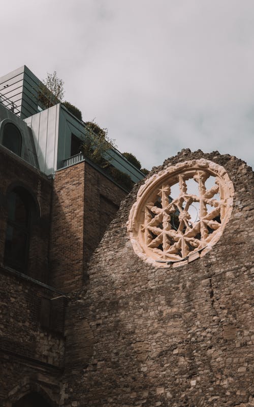 Medieval Church Wall with Rosette and Modern Building