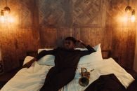 Man in Black Jacket Lying on Bed