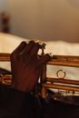 Person Playing Trumpet on Bed
