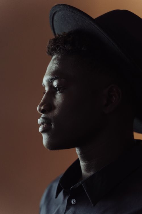 Free Side profile portrait of a man wearing a hat, showcasing fashion and style. Stock Photo